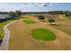 Aerial view of multiple putting greens on the community golf course at 11744 Wheatfield Loop, Hudson, FL 34667