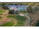 A lush green golf course surrounds the community clubhouse with a sparkling pool at 11744 Wheatfield Loop, Hudson, FL 34667