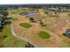 Aerial view of the community golf course featuring water hazards and lush landscaping at 11744 Wheatfield Loop, Hudson, FL 34667