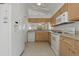 Well-lit kitchen with ample storage and a full-size refrigerator at 11744 Wheatfield Loop, Hudson, FL 34667
