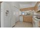 Bright kitchen with white appliances and tile flooring at 11744 Wheatfield Loop, Hudson, FL 34667