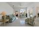 Bright living room with tile flooring, ceiling fan, and comfortable seating at 11744 Wheatfield Loop, Hudson, FL 34667