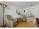 Comfortable living room with wood floors, neutral walls, and an open view into the dining area at 11744 Wheatfield Loop, Hudson, FL 34667