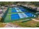 Aerial view of fully fenced pickleball courts with parking nearby at 11744 Wheatfield Loop, Hudson, FL 34667