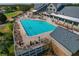 Large community pool with ample lounge seating and golf course views at 11744 Wheatfield Loop, Hudson, FL 34667
