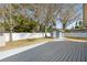 Backyard featuring a deck, fenced yard, and shed with tidy landscaping at 1310 Georgia Ave, Dunedin, FL 34698