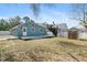 View of the backyard with a shed and wooden deck on a sunny day at 1310 Georgia Ave, Dunedin, FL 34698