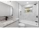 Well-lit bathroom featuring a shower-over-tub, granite countertop, and modern fixtures at 1310 Georgia Ave, Dunedin, FL 34698