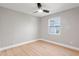 Bright bedroom featuring light walls, wood-look floors, and a ceiling fan at 1310 Georgia Ave, Dunedin, FL 34698