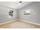 Bright bedroom with wood floors and two windows that allow natural light at 1310 Georgia Ave, Dunedin, FL 34698