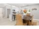 Open-concept dining and kitchen area with light, neutral tones, modern appliances, and bar seating at 1310 Georgia Ave, Dunedin, FL 34698