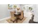 Sunny dining area features a dark wood table with woven chairs, paired with light wood floors and bright, natural lighting at 1310 Georgia Ave, Dunedin, FL 34698