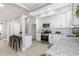 Renovated kitchen with new white cabinets, subway tile backsplash, stainless appliances, and a large island at 1310 Georgia Ave, Dunedin, FL 34698