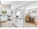 Open concept kitchen featuring white cabinets, stainless appliances, large island, and a dining area at 1310 Georgia Ave, Dunedin, FL 34698