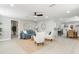 Open floor plan with light gray walls, a blue sofa, and an adjacent dining area with a view into the kitchen at 1310 Georgia Ave, Dunedin, FL 34698