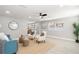 Cozy living room with a blue couch, neutral armchairs, and light wood floors for a modern and comfortable look at 1310 Georgia Ave, Dunedin, FL 34698