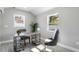 Well-lit home office with wood floors, gray walls, and an industrial-style desk at 1310 Georgia Ave, Dunedin, FL 34698