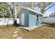 Exterior shot of the shed in the backyard with stone paver and mulch border at 1310 Georgia Ave, Dunedin, FL 34698