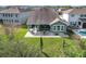 Aerial view of a home with a backyard featuring a patio, fire pit, and putting green at 14855 Renaissance Ave, Odessa, FL 33556