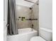 Clean bathroom features neutral tile surround with a built in soap niche and shower/tub combo at 14855 Renaissance Ave, Odessa, FL 33556