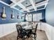 Stylish dining room with coffered ceilings, chess table, and guitars decorating the vibrant blue wall at 14855 Renaissance Ave, Odessa, FL 33556