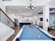 Spacious game room with a pool table, chandelier, and seamless flow to other living spaces at 14855 Renaissance Ave, Odessa, FL 33556