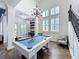 Bright game room with a pool table, bar area, and plenty of natural light from the large windows at 14855 Renaissance Ave, Odessa, FL 33556