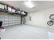 Spacious garage with epoxy floor, overhead storage racks, and wall-mounted bike rack at 14855 Renaissance Ave, Odessa, FL 33556