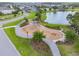 Playground in a lakeside community with walking path, manicured grass, and neighborhood homes at 14855 Renaissance Ave, Odessa, FL 33556