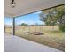 Covered back patio with a peaceful view of the open field and sky at 15111 Peach Bloom Rd, Brooksville, FL 34614