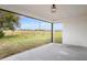 Covered back patio with a view of an expansive fenced yard at 15111 Peach Bloom Rd, Brooksville, FL 34614