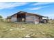 Functional barn with an open-air design, ideal for livestock, hay storage, or rural operations at 15111 Peach Bloom Rd, Brooksville, FL 34614