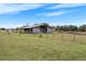 Rustic barn structure with fenced pasture, offering ample space for livestock at 15111 Peach Bloom Rd, Brooksville, FL 34614