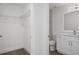 A storage area combines shelving with a half bathroom featuring modern fixtures and finishes at 15111 Peach Bloom Rd, Brooksville, FL 34614