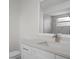 Bright bathroom features a white vanity with a granite countertop and a shower stall with gray tile at 15111 Peach Bloom Rd, Brooksville, FL 34614