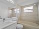 Cozy bathroom featuring a tub and shower combo, with white vanity and large mirror at 15111 Peach Bloom Rd, Brooksville, FL 34614