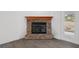 Stone fireplace with a hearth, and gray floors, located in the living room at 15111 Peach Bloom Rd, Brooksville, FL 34614