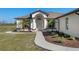 Inviting front entrance features a curved walkway and attractive landscaping, enhancing curb appeal at 15111 Peach Bloom Rd, Brooksville, FL 34614