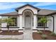 Inviting home exterior displaying classic architecture, neat landscaping, and a welcoming entrance at 15111 Peach Bloom Rd, Brooksville, FL 34614