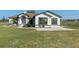 Charming single-story home featuring a well-manicured lawn, tasteful landscaping, and covered front porch at 15111 Peach Bloom Rd, Brooksville, FL 34614