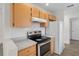 Bright kitchen featuring wood cabinets, stainless steel appliances and modern white subway tile backsplash at 15111 Peach Bloom Rd, Brooksville, FL 34614