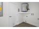 Bright laundry room featuring a water heater, shelf and access door at 15111 Peach Bloom Rd, Brooksville, FL 34614