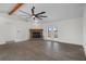 Spacious living room featuring a stone fireplace, ceiling fan, and hardwood floors at 15111 Peach Bloom Rd, Brooksville, FL 34614