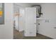 A utility area including a water heater with views into a kitchen featuring ample cabinetry at 15111 Peach Bloom Rd, Brooksville, FL 34614