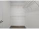 Walk-in closet with wood look flooring and white wire shelving at 15111 Peach Bloom Rd, Brooksville, FL 34614