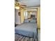 Bedroom with murphy bed, ceiling fan, and mirror at 2164 Vista Del Sol Cir # 505, Lutz, FL 33558