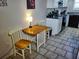 Charming dining area with a wooden table, chairs, and a view of the adjacent kitchen at 2164 Vista Del Sol Cir # 505, Lutz, FL 33558