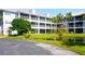 White two-story condo building with pond and landscaping at 2164 Vista Del Sol Cir # 505, Lutz, FL 33558