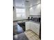 Modern kitchen with white cabinets, black appliances, and dark countertops at 2164 Vista Del Sol Cir # 505, Lutz, FL 33558
