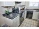 Modern kitchen with white cabinets, black appliances, and dark countertops at 2164 Vista Del Sol Cir # 505, Lutz, FL 33558